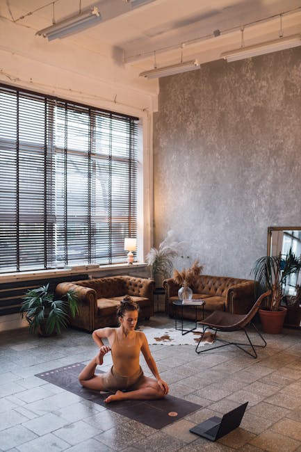 Person doing a gentle stretch on a yoga mat in a modern living room